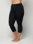Black leggings worn by a Woman on a plain background