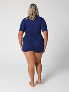 Person wearing a blue outfit with a matching top and shorts on a white background