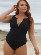 Woman wearing a black swimsuit on a beach