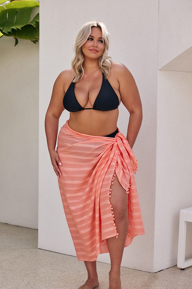 Blonde model wearing coral sarong
