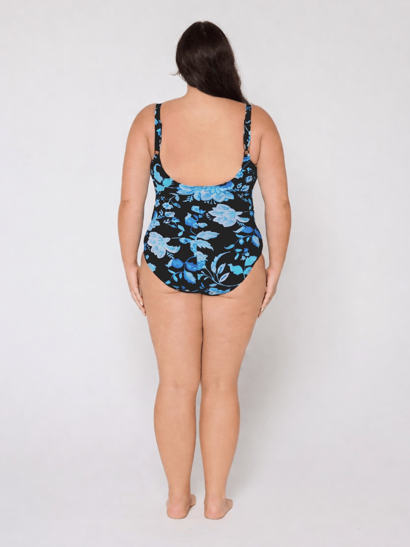 Woman wearing a floral swimsuit on a white background