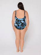 Woman wearing a floral swimsuit on a white background