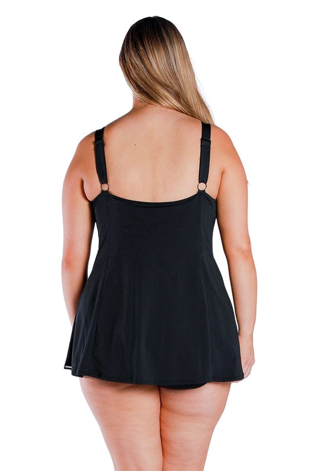 back of blonde women wearing a size 16 black swim dress with front panel turquoise floral detail