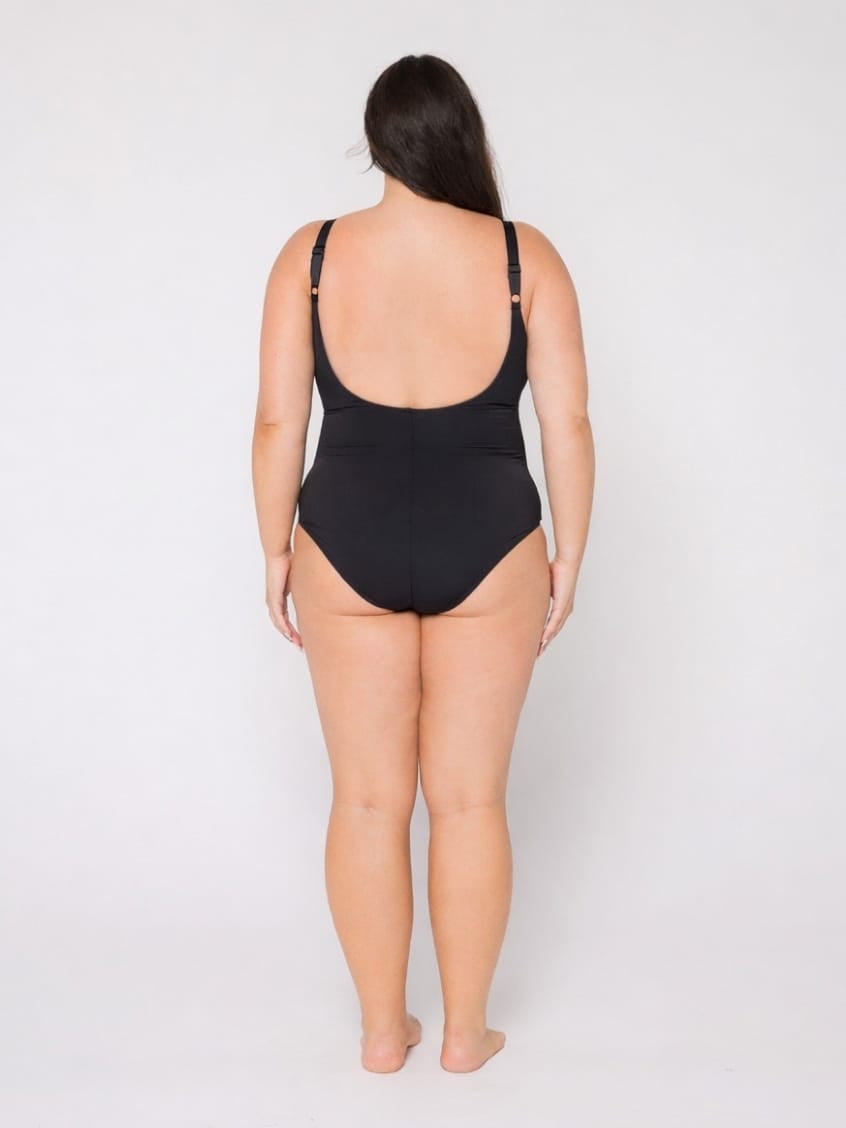 Woman wearing a black swimsuit on a white background