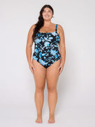 Woman wearing a blue floral swimsuit on a white background