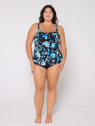 Woman wearing a floral-patterned swimsuit top on a white background