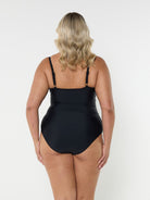Blonde model showing back of black criss cross one piece
