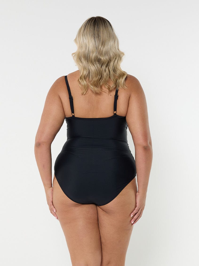 Blonde model showing back of black criss cross one piece