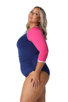 Model showing side of navy and pink full coverage swimsuit