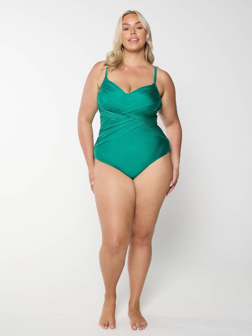 Woman wearing a green swimsuit on a white background