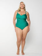 Woman wearing a green swimsuit on a white background