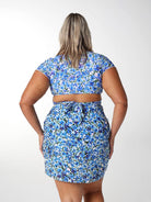 Model showing back of blue floral short sarong
