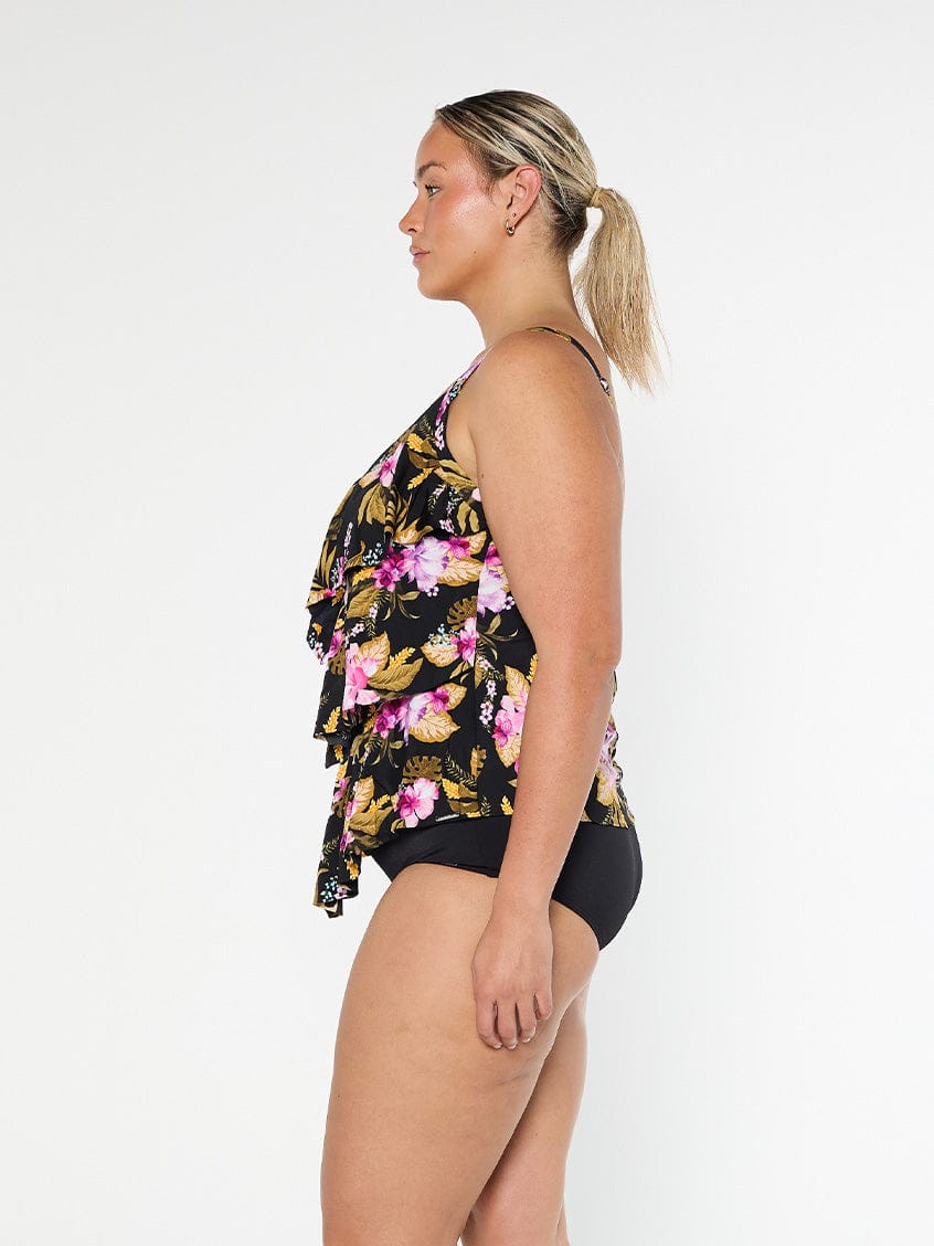 Blonde model shows the side of pink floral chlorine resistant ruffled tankini top  with adjustable straps