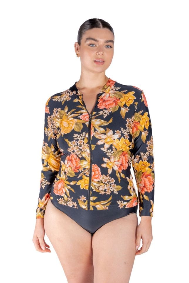 Model wearing black floral long sleeve rash vest with zip front