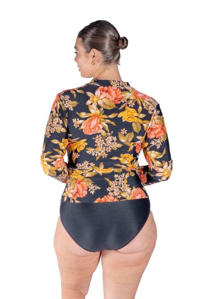 back profile of model wearing a floral long sleeve rashie with yellow and coral flowers