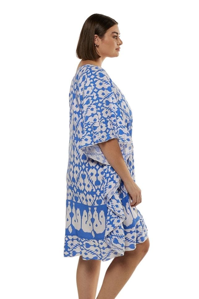 side profile of model wearing powder blue and white block printed knee length beach dress
