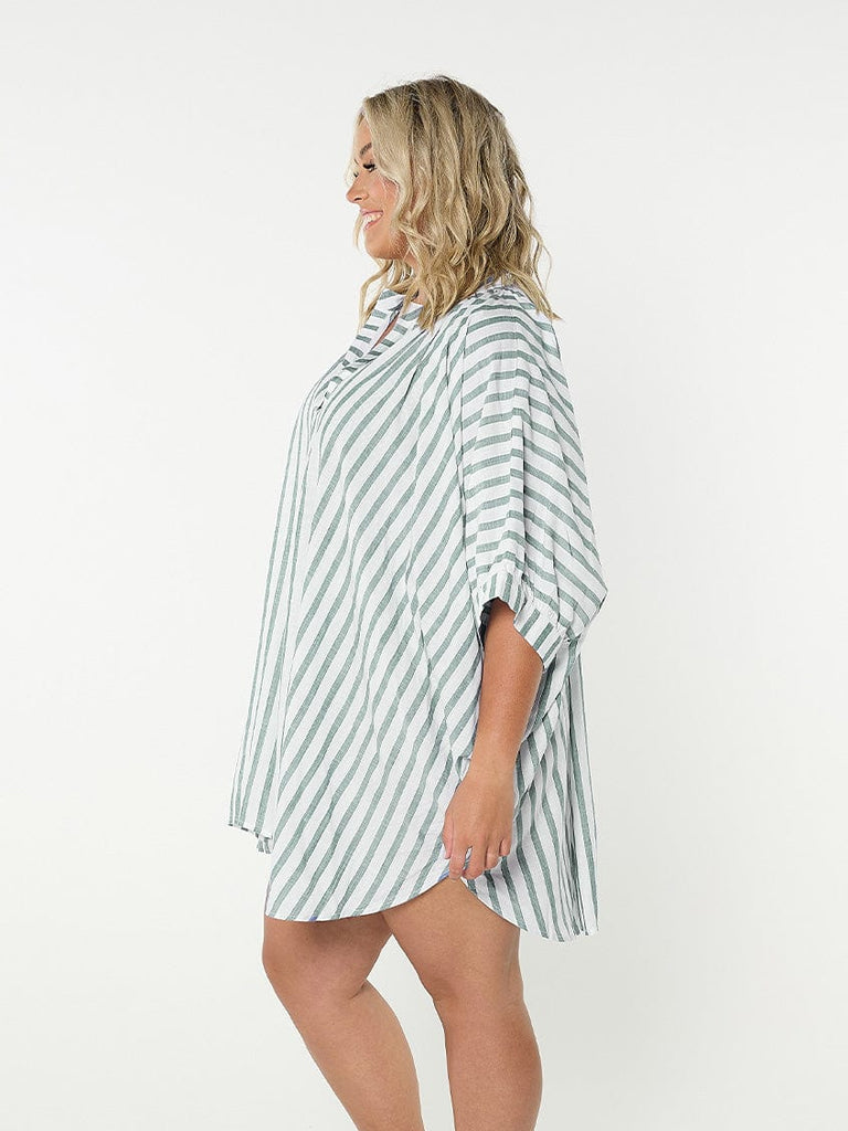 Model showing side of green and white striped coverup