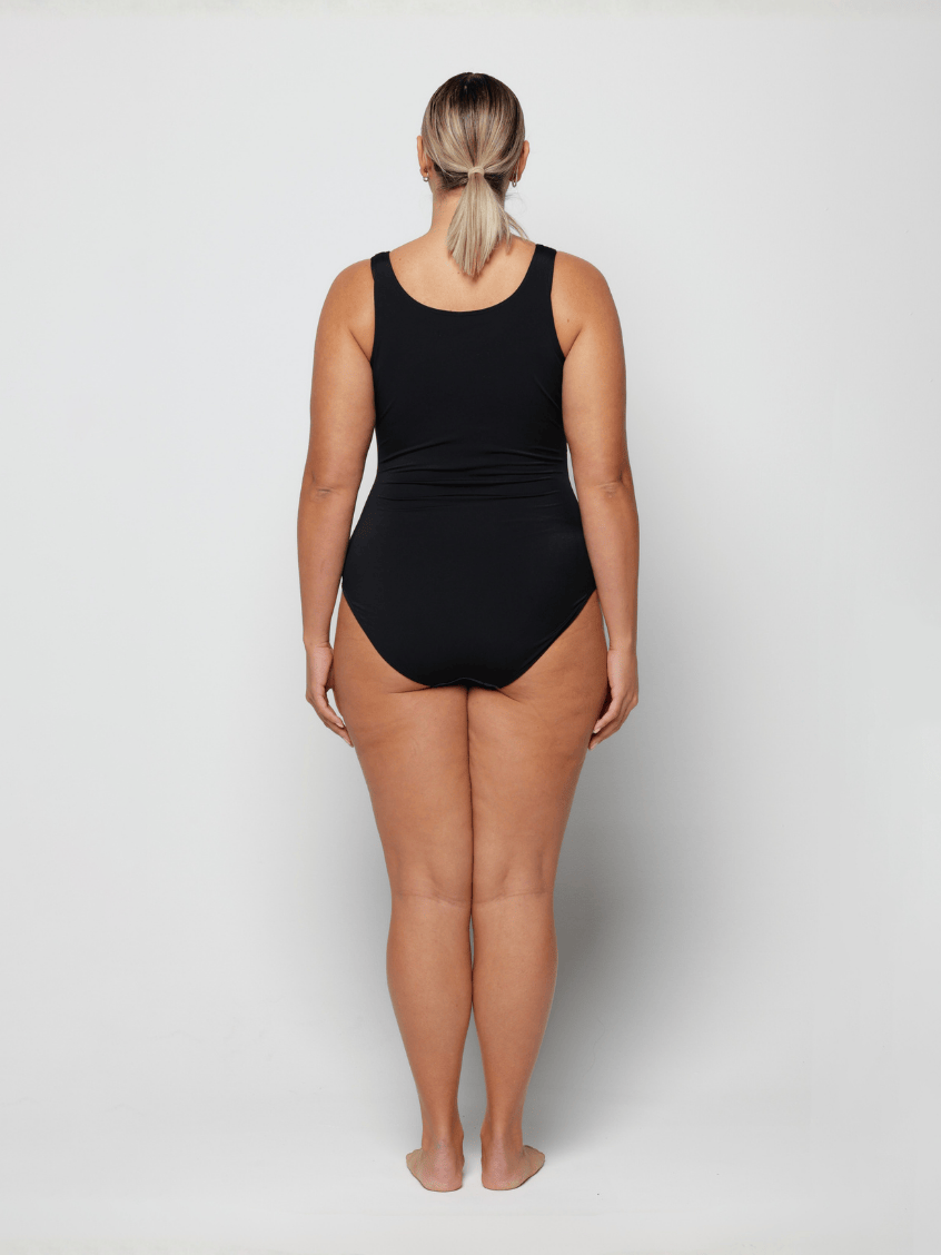 Person wearing a black swimsuit on a white background