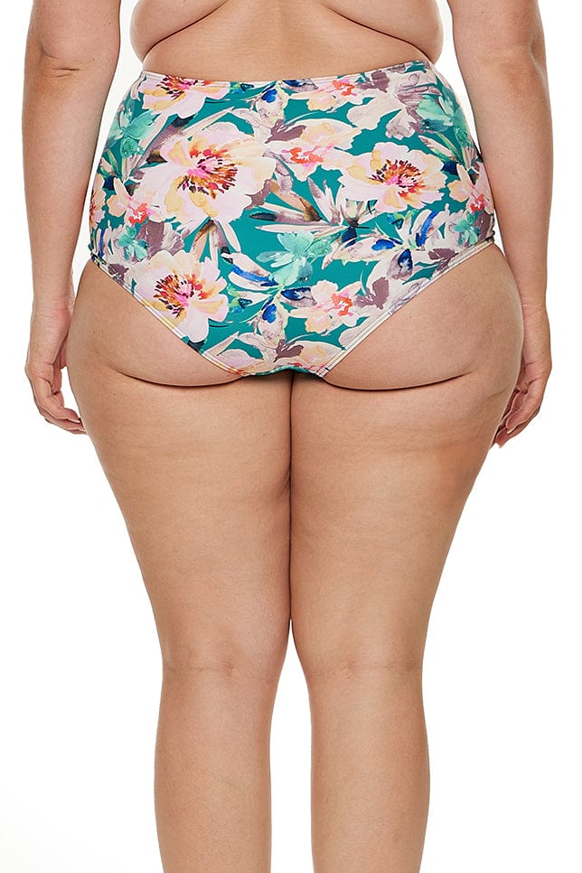 model wears high waisted tummy control swim bottom in green floral