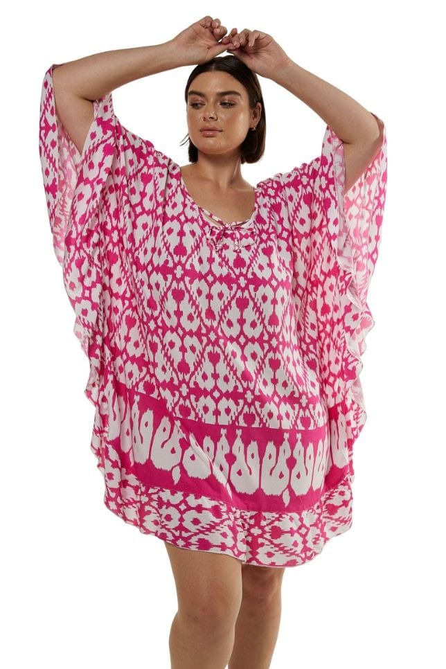 Brunette model wearing block printed pink sun dress