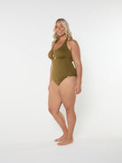 Woman wearing a green swimsuit on a white background