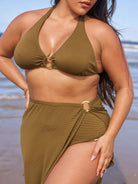 Brunette model wears textured khakimaxi skirt with side split