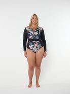 Woman wearing a black floral swimsuit with a hood on a white background
