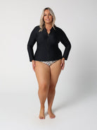 Woman wearing a black wetsuit on a white background