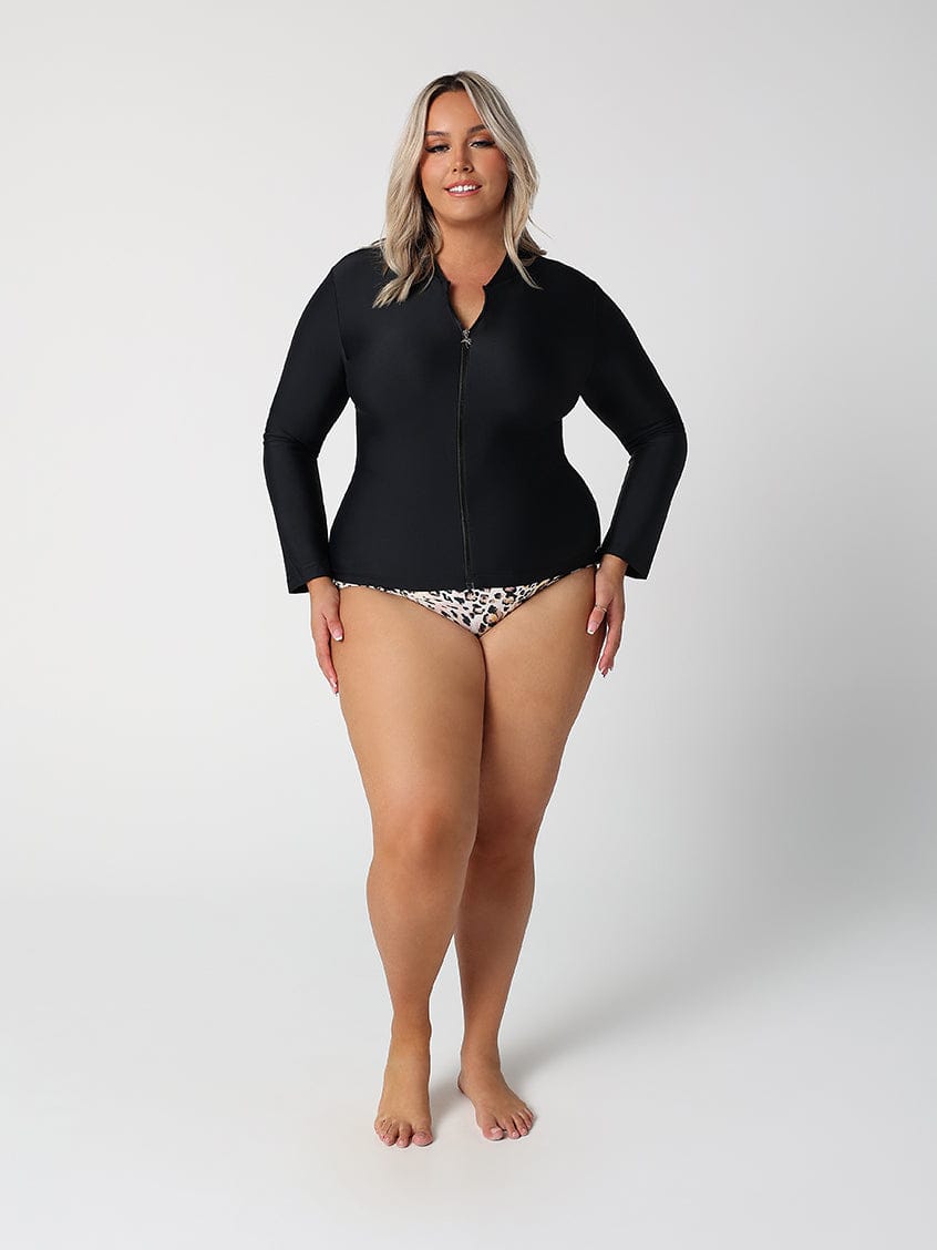 Woman wearing a black wetsuit on a white background