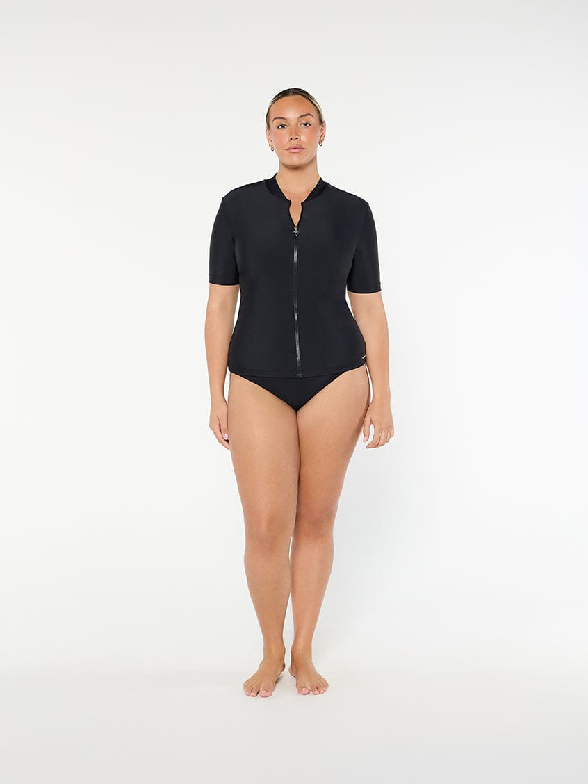 Person wearing a black swimsuit with a zipper on a white background