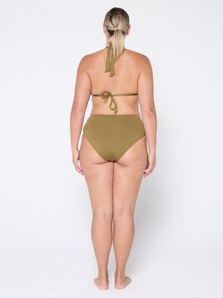 Woman wearing a green bikini on a white background