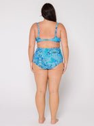 Woman wearing a blue floral bikini set on a white background