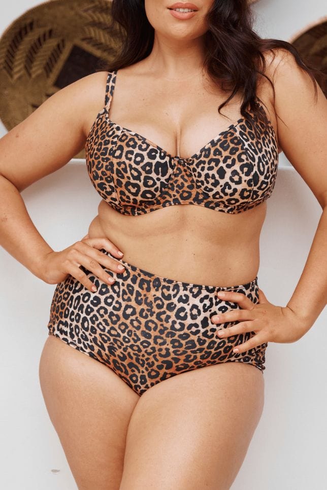 Model stands with hands on hips, she is wearing a leopard print bikini. The bikini bottoms are high waisted and full coverage.
