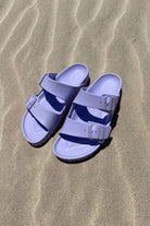 Light purple womens slide on sandals on the beach