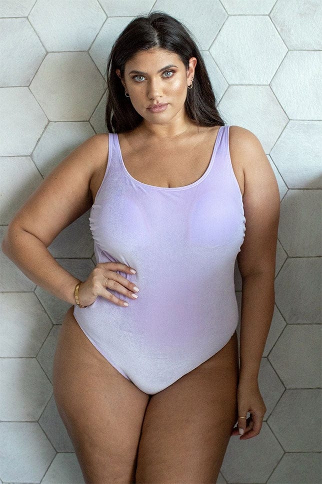 model wearing lilac velvet one piece swimsuit with high cut sides