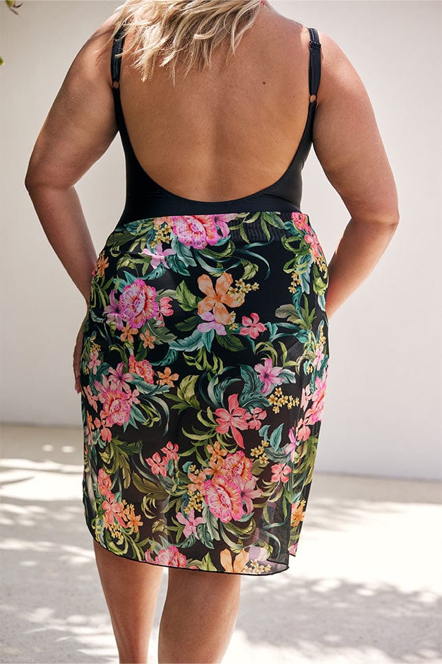 Model showing back of scooped black one piece with floral mesh skirt