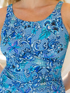 Blue patterned dress on a person against a neutral background
