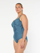 model showing side of metallic grey criss cross one piece swimsuit