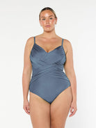 model wearing metallic grey criss cross one piece