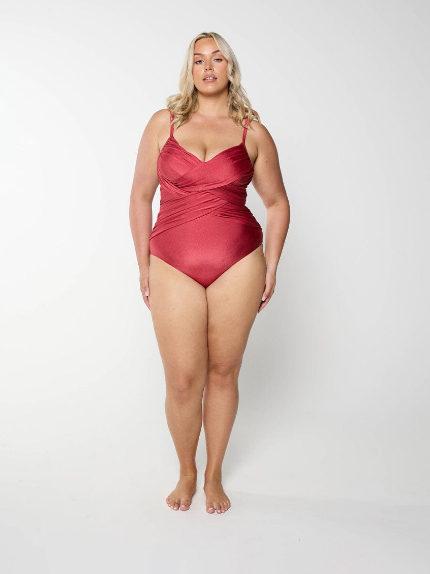 Woman wearing a metallic sangria swimsuit against a white background