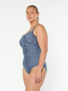 model showing side of metallic grey criss cross one piece swimsuit
