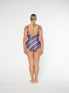 Woman wearing a striped swimsuit on a white background