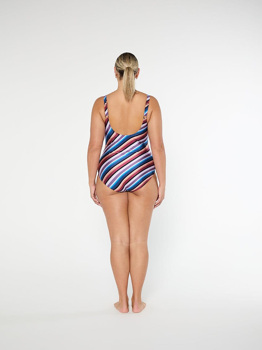 Woman wearing a striped swimsuit on a white background