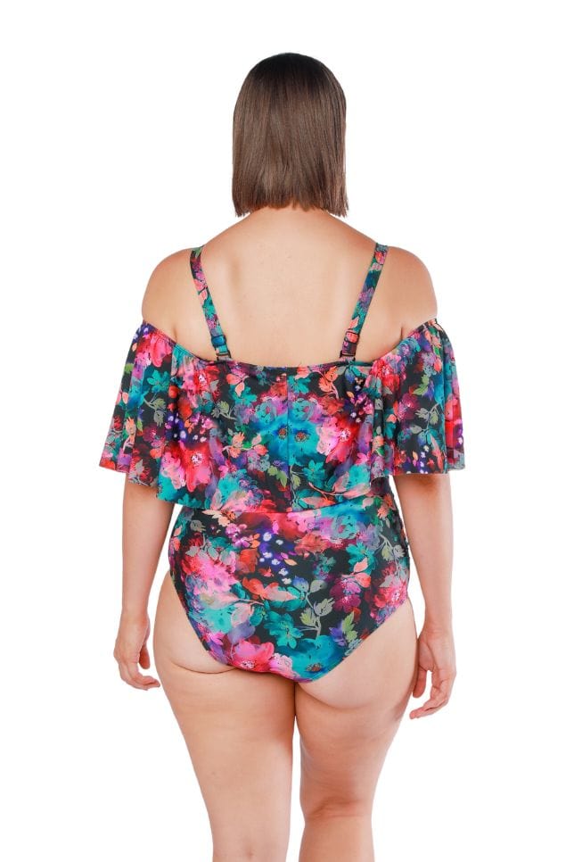 Back shot of model wearing off shoulder frill top one piece in pink and blue floral print