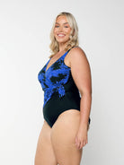 model showing side of blue floral crossover one piece