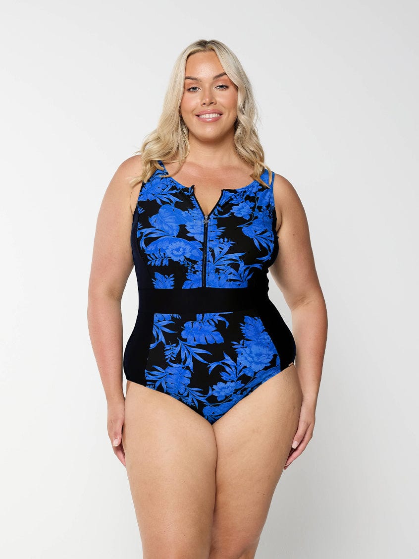 model wearing blue and black floral women's zip up one piece