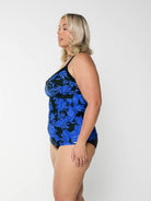 model showing side of blue and black floral swim tankini