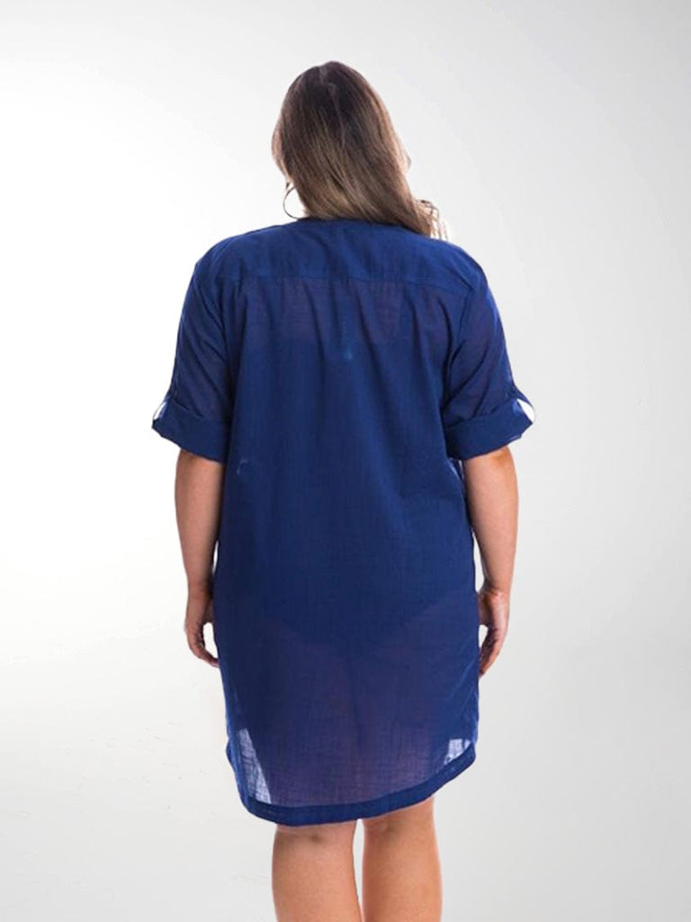 Back of model in studio wearing overshirt with rolled up sleeves in navy cotton