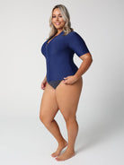 Woman wearing a blue swimsuit on a white background