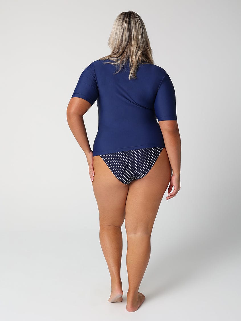 Person wearing a blue swimsuit with a patterned bottom section on a white background